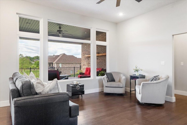 living area with ceiling fan, dark wood-style flooring, and baseboards
