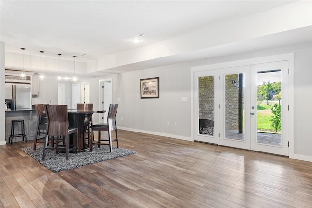 dining room with dark wood-style flooring and baseboards