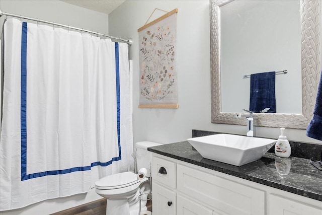 full bathroom with toilet, vanity, and wood finished floors