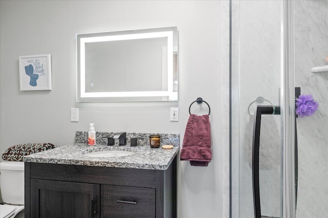 bathroom with vanity and toilet