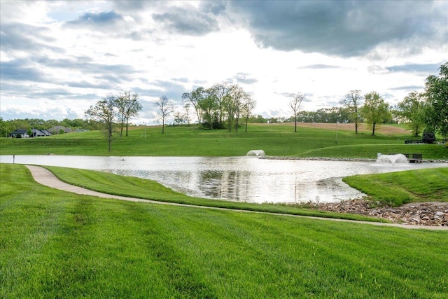 view of community featuring a water view and a yard