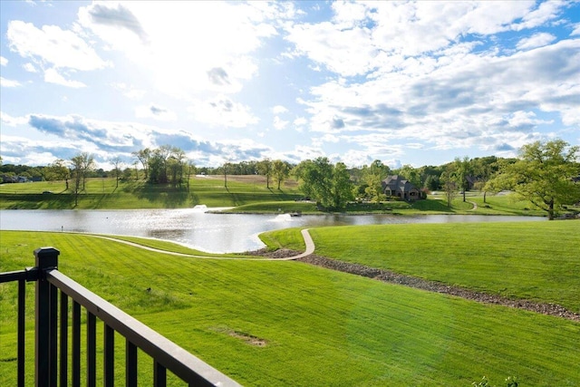 view of property's community with a water view and a yard