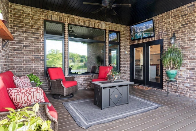 wooden deck featuring a ceiling fan and french doors
