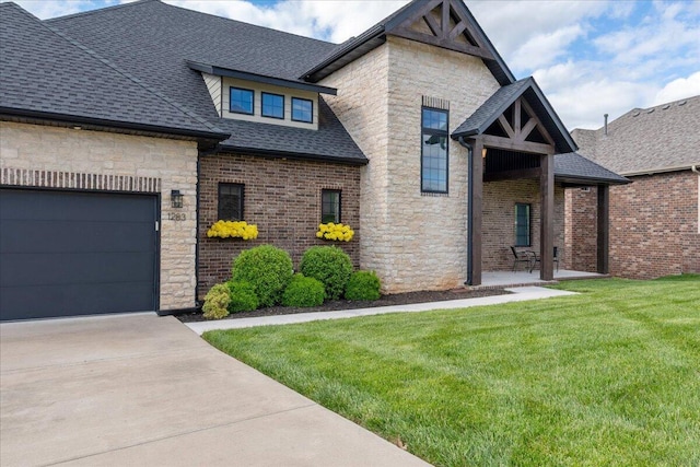 craftsman-style home featuring an attached garage, stone siding, driveway, a front lawn, and a shingled roof