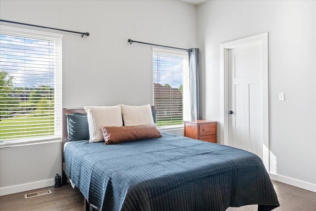 bedroom featuring visible vents, wood finished floors, and baseboards