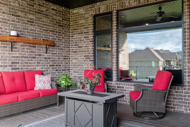 wooden deck featuring a ceiling fan and an outdoor living space