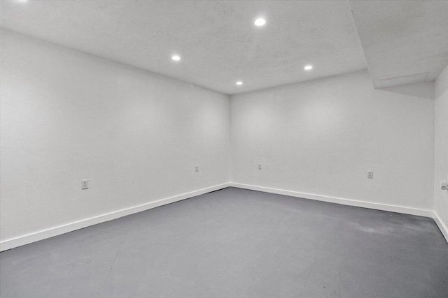 finished basement featuring baseboards and recessed lighting