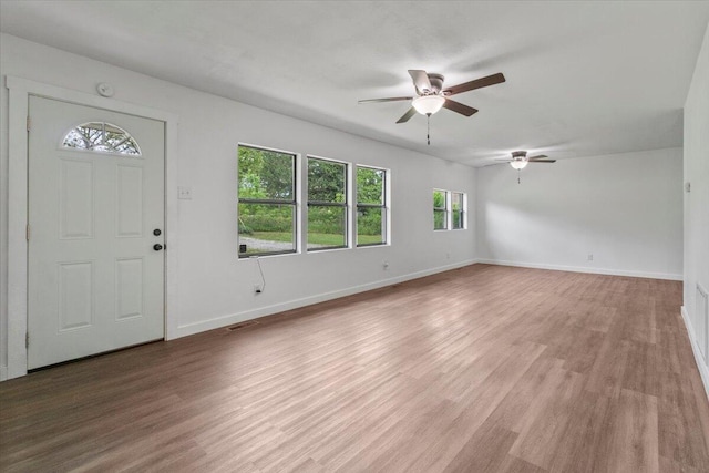 entryway with ceiling fan, light wood-style flooring, and baseboards