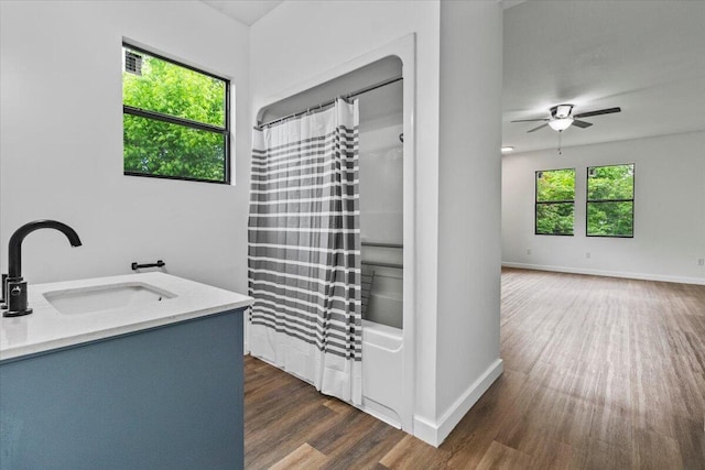 full bath featuring wood finished floors, baseboards, ceiling fan, and a sink