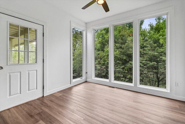 unfurnished sunroom featuring visible vents