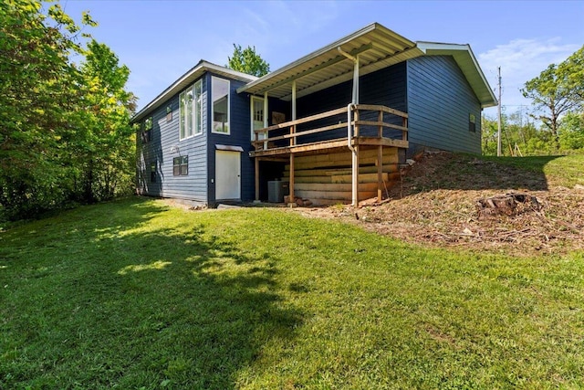 back of house with a lawn, central AC unit, and a wooden deck