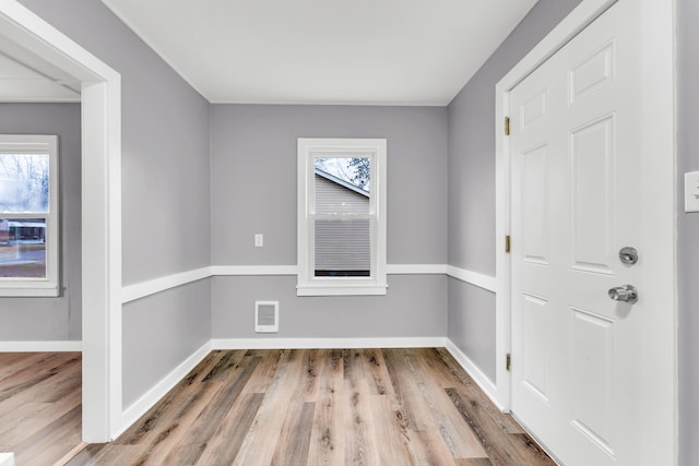 empty room featuring wood finished floors and baseboards