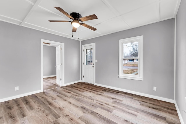 spare room featuring a ceiling fan, baseboards, and wood finished floors
