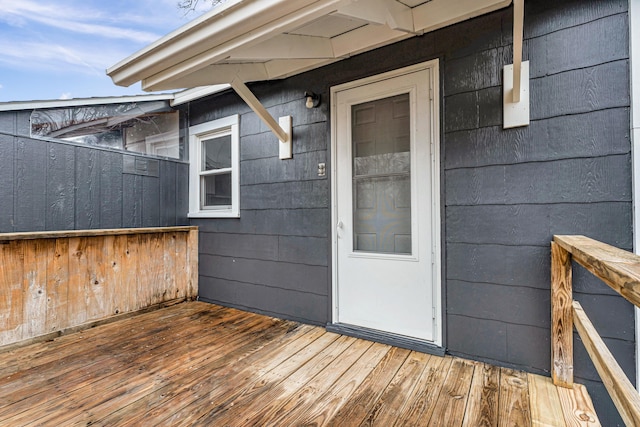 view of exterior entry with a wooden deck