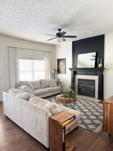 1118 E Ritter St, Republic, MO 65738 - living area featuring a tile fireplace, a textured ceiling, wood finished floors, and a ceiling fan