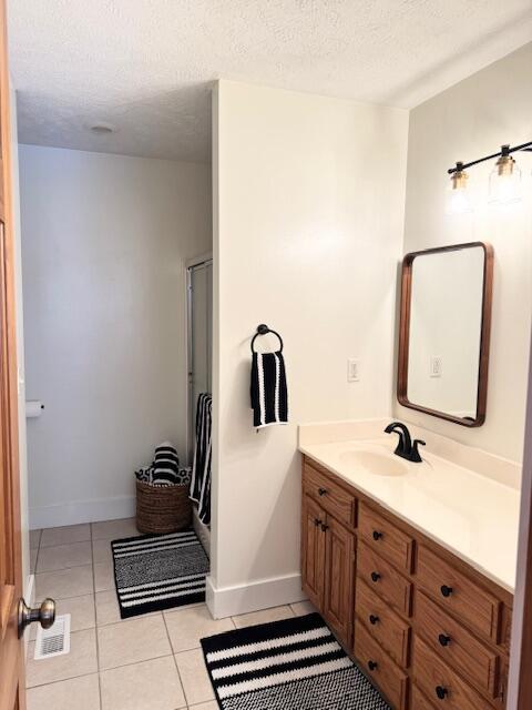 1118 E Ritter St, Republic, MO 65738 - full bath featuring baseboards, tile patterned floors, vanity, and a textured ceiling