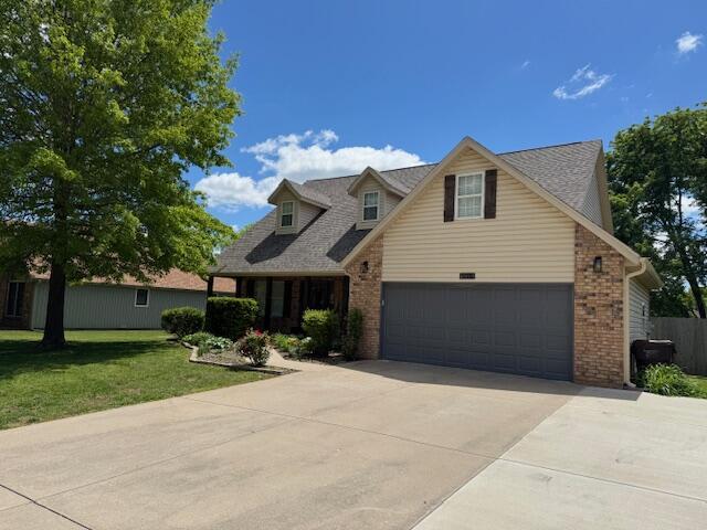 1118 E Ritter St, Republic, MO 65738 - view of front of home featuring driveway, a shingled roof, brick siding, and a front yard