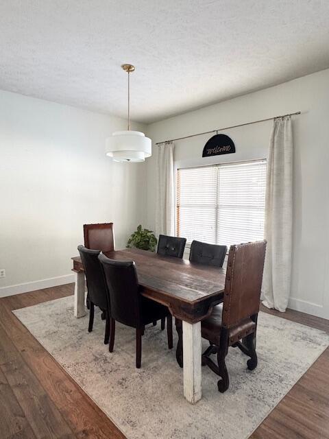 1118 E Ritter St, Republic, MO 65738 - dining area with wood finished floors, baseboards, and a textured ceiling
