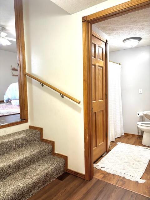 1118 E Ritter St, Republic, MO 65738 - stairs featuring ceiling fan, a textured ceiling, baseboards, and wood finished floors