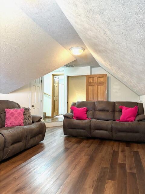 1118 E Ritter St, Republic, MO 65738 - living area featuring vaulted ceiling, a textured ceiling, and wood finished floors