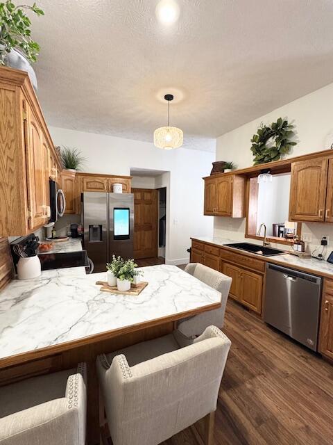 1118 E Ritter St, Republic, MO 65738 - kitchen featuring stainless steel appliances, a sink, a peninsula, dark wood-type flooring, and light countertops