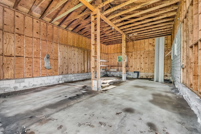 miscellaneous room featuring unfinished concrete flooring and a garage