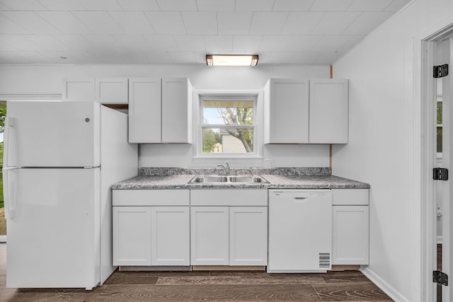 kitchen with white cabinetry, dark wood-style flooring, white appliances, and a sink