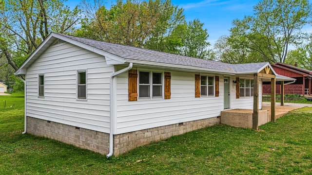 view of home's exterior with a yard, a shingled roof, and crawl space