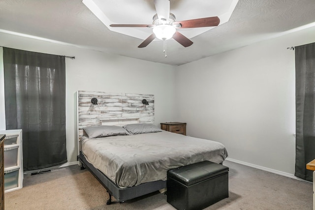 carpeted bedroom featuring baseboards and ceiling fan
