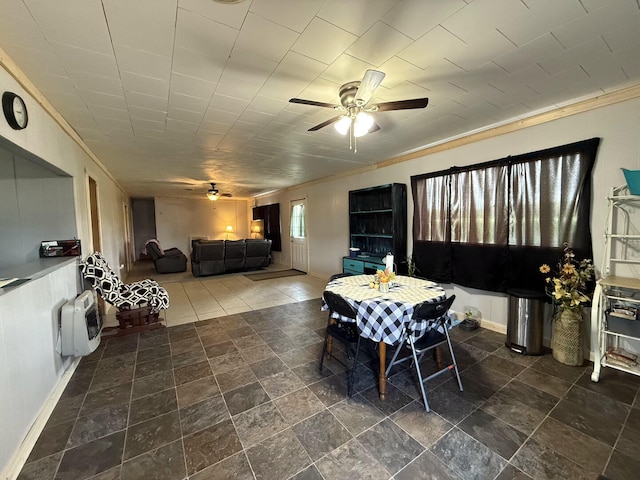 1398 County Road 670, Birch Tree, MO 65438 - dining room with heating unit, stone finish floor, baseboards, ceiling fan, and ornamental molding