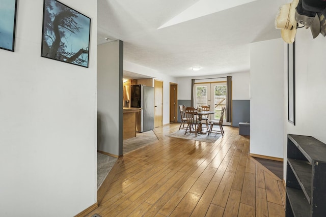 interior space with light wood finished floors and baseboards