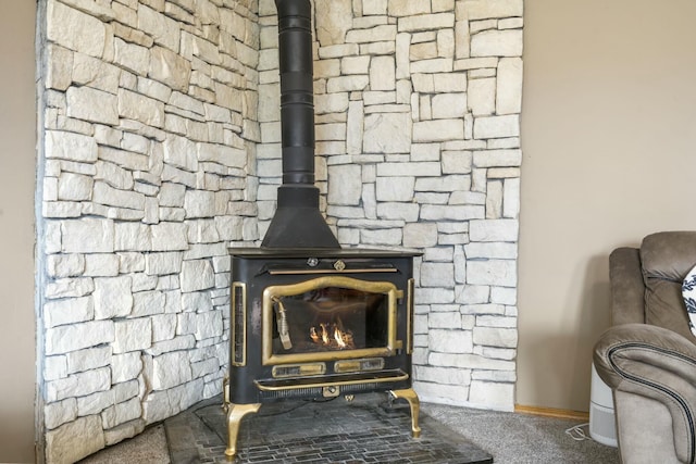 room details with a wood stove and carpet floors