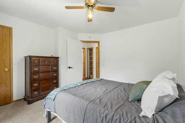 bedroom with light colored carpet, baseboards, and ceiling fan