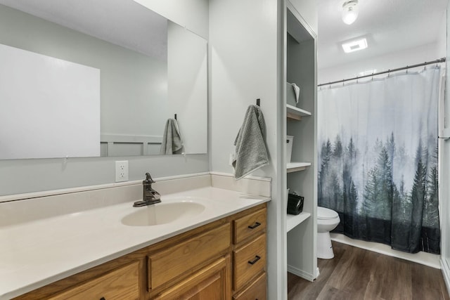 full bath featuring toilet, a shower with curtain, vanity, and wood finished floors