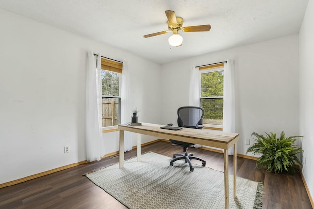 office space featuring wood finished floors, baseboards, and a healthy amount of sunlight