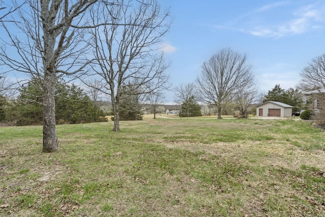 view of yard featuring a detached garage and an outdoor structure
