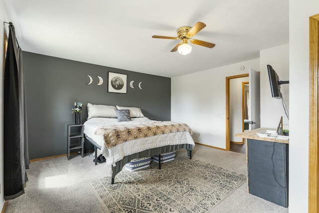 carpeted bedroom featuring baseboards and a ceiling fan
