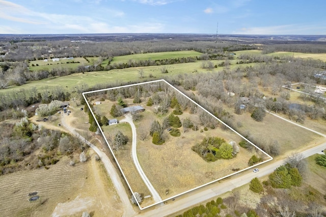 birds eye view of property with a rural view