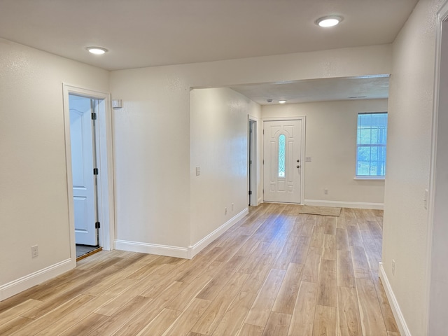 entryway featuring light wood finished floors and baseboards