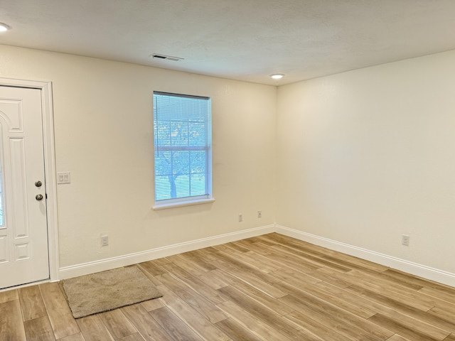 entryway featuring baseboards, visible vents, and light wood-style floors