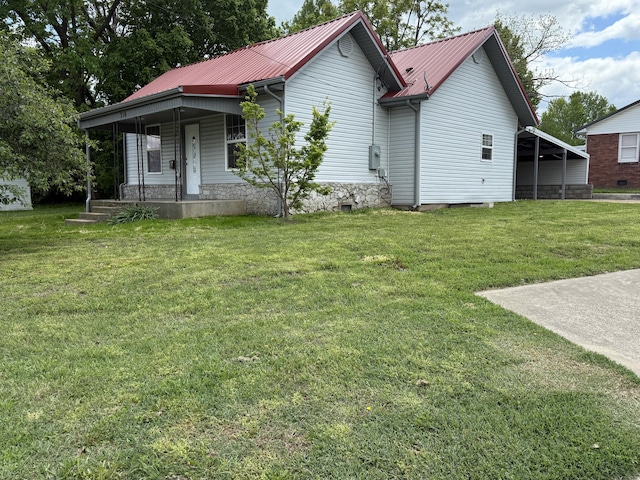view of home's exterior with a porch, metal roof, and a lawn