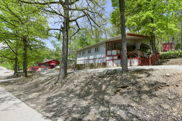 view of front of home with a porch and stairway