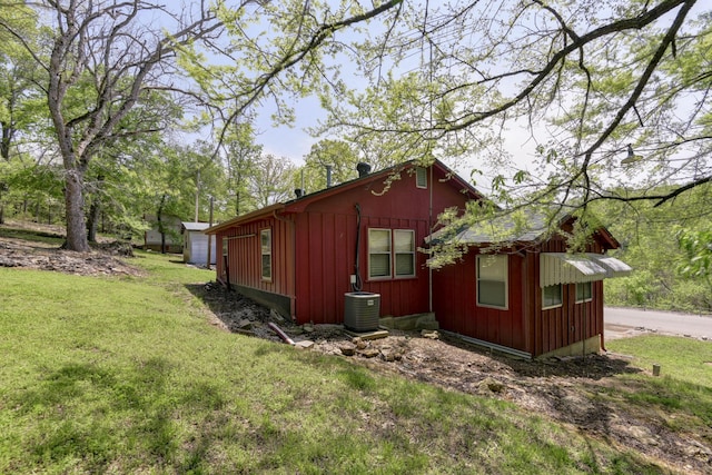 view of property exterior featuring a lawn and central air condition unit