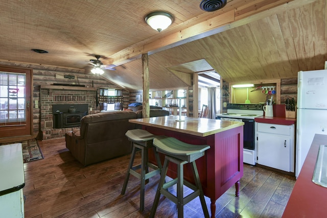 kitchen featuring plenty of natural light, dark wood-type flooring, range with electric stovetop, and wooden counters