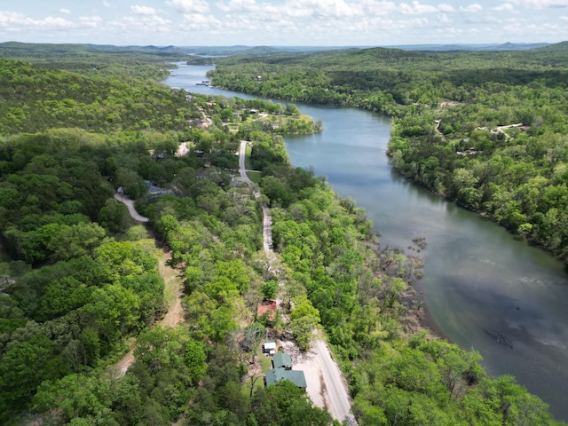 drone / aerial view with a water view and a wooded view