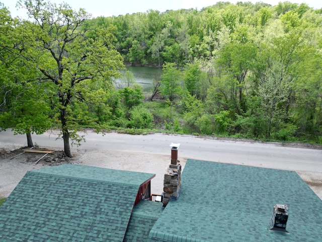 exterior space featuring a water view and a forest view