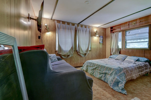 bedroom featuring carpet flooring and wooden walls