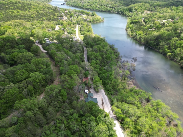 drone / aerial view featuring a water view and a view of trees