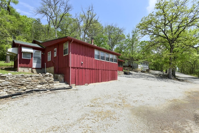 view of property exterior featuring driveway and entry steps