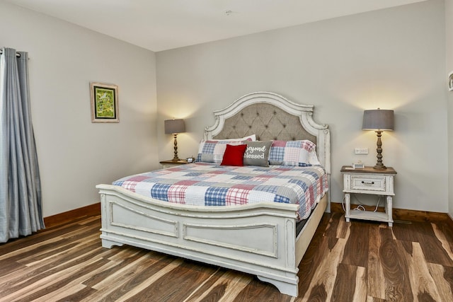 bedroom featuring wood finished floors and baseboards